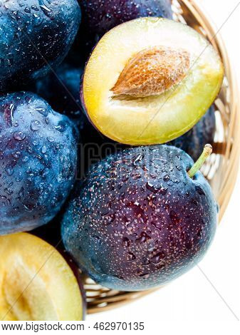 Fresh Plums In Basket On White Background.