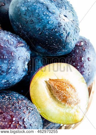Fresh Plums In Basket On White Background.