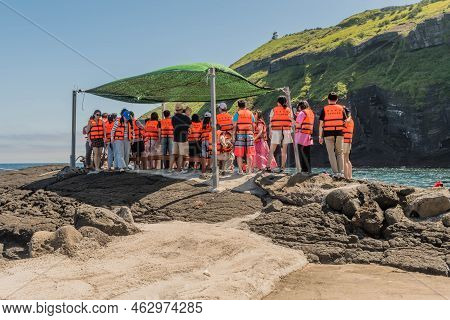 Udo Island, South Korea; June 22, 2022: Unidentified Tourist Wearing Life Vest Waiting To Board Boat
