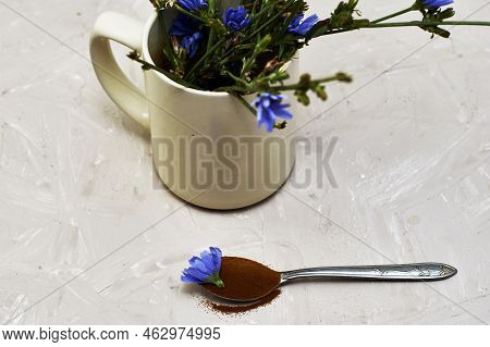 A Spoon With Chicory Flower And Chicory Powder And Chicory Flowers In A Coffee Mug