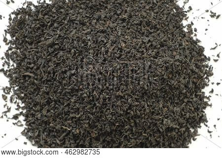 Pile Of Black Dry Tea On White. Black Tea Leaves. Close Up, Macro. Top View. Texture. Full Frame. Co