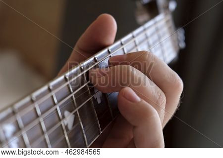Man Playing Guitar Chord. Unrecognizable Person Rehearsing. Strumming Acoustic Guitar. Musician Play