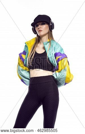 Closeup Portrait Of Young Caucasian Female  Sportwoman In Fitness Outfit And Baseball Cap With Wirel