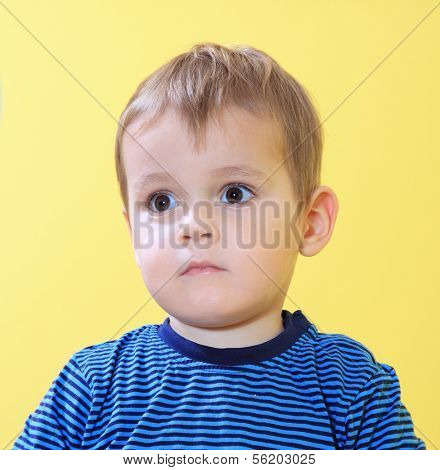 Sad little toddler missing his mum in kindergarten.