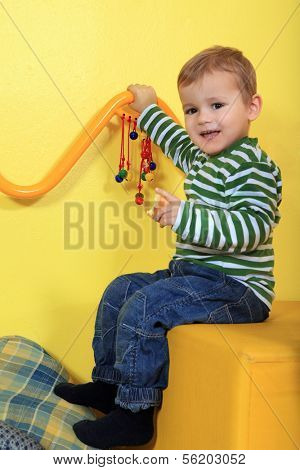 Cute european toddler having fun in kindergarten.