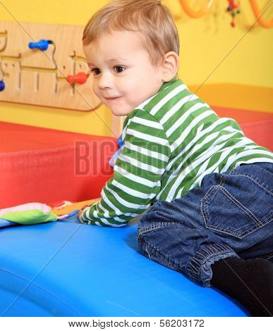 Cute caucasian toddler having fun in kindergarten.