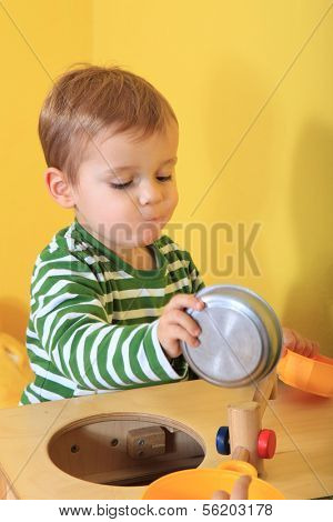 Cute caucasian toddler playing in kindergarten.