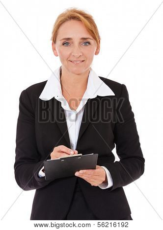 Attractive mature businesswoman writing on clipboard. All on white background.
