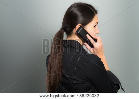 Secretive Businesswoman Talking On Her Mobile