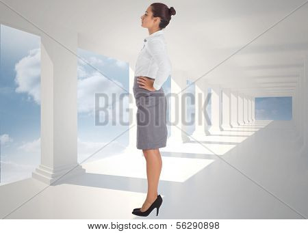 Focused businesswoman against bright white hall with columns