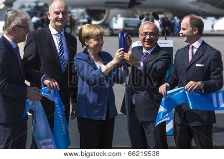 BERLIN, GERMANY - MAY 20, 2014: German Chancellor Angela Merkel, Turkish Minister of transport Lutfi Elvan and CEO Mr Christian (C.-R.) open up the International aviation and space exhibition ILA.