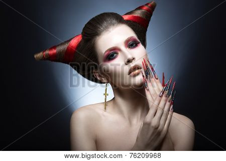 The girl in an image of the demon-tempter with long nails and haircut in the form of horns.