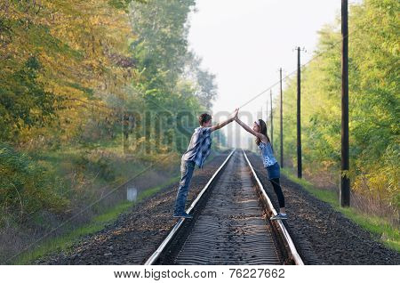 Teen Girl And Boy Posing On Rails