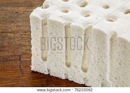 a sample of natural latex used in organic mattresses over grunge wood