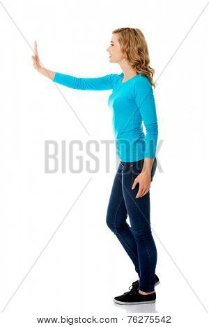 Side view woman touching imaginary screen.