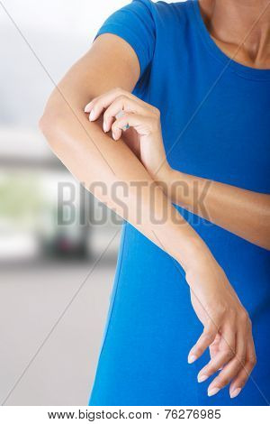 Young woman scratching her self
