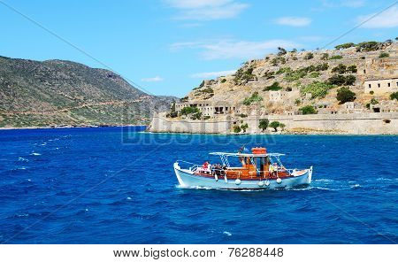Spinalonga, Greece - May 14: The Motor Yacht With Tourists Is Near Spinalonga Island On May 14, 2014