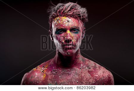 Creepy portrait of a halloween man with bloody body art and face art.
