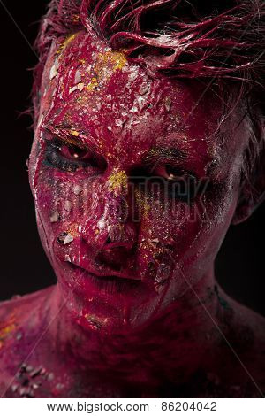 Creepy portrait of a halloween man with bloody body art and face art.