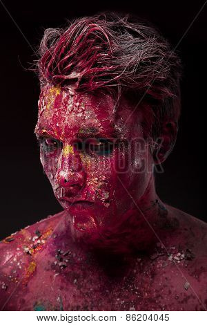 Creepy portrait of a halloween man with bloody body art and face art.