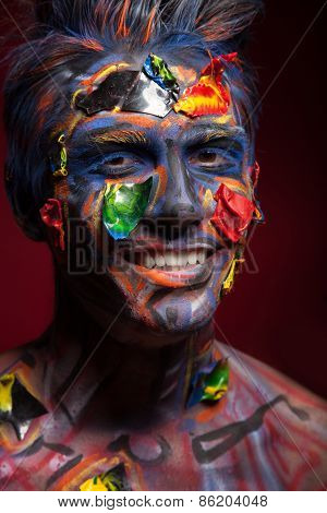 A creepy portrait of halloween moor with colour body art.