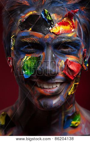 A creepy portrait of halloween moor with colour body art.
