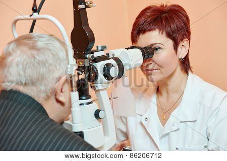 Optometry concept. female optometrist optician doctor examines eyesight of female patient in eye ophthalmological clinic 