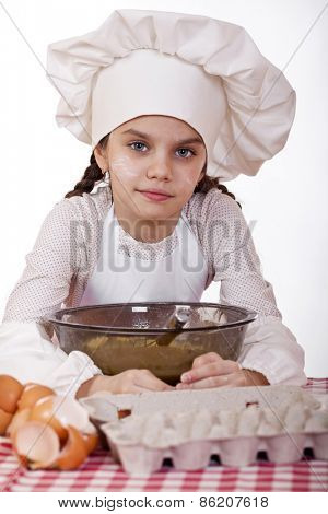 Cooking and people concept - smiling little girl in cook hat, isolated on white background