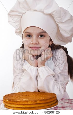 Cooking and people concept - smiling little girl in cook hat, isolated on white background