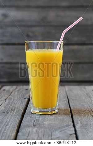 Glass Of Orange Juice On A Wooden Table