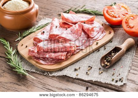 Slices Of Salami On The Wooden Board