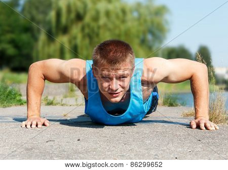 Handsome Young Man In Good Shape Doing Push-up While Outdoor Training