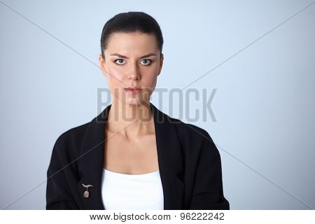 A young woman standing, isolated on graybackground
