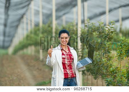 Satisfied Woman Agronomist In Orchard