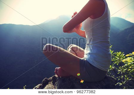 young yoga woman sit meditation on sunrise mountain peak