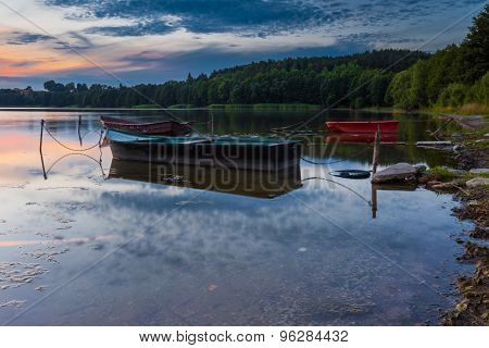 Beautiful Lake Sunset With Fisherman Boat