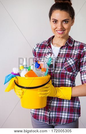 Young Pretty Woman Holding Cleaning Tools And Products In Bucket, On White Citchen,  Cleaning Concep