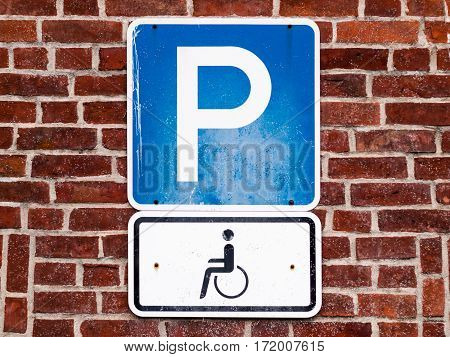 Close-up of a dirty parking sign for disable people