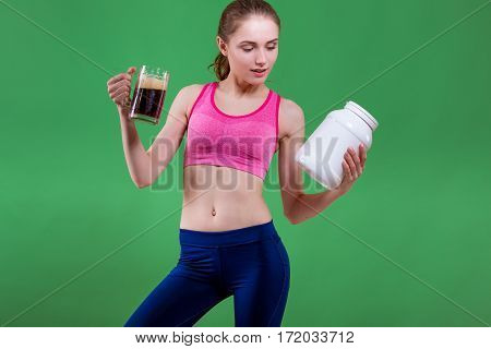 Caucasian girl that chooses to drink beer or eat of sports nutrition. Choice concept.