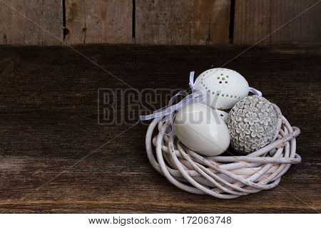 Easter eggs hunt - white eggs nest on wooden background