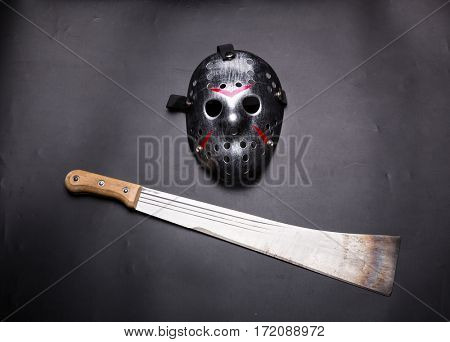 Murderer hockey mask and machete isolated on black