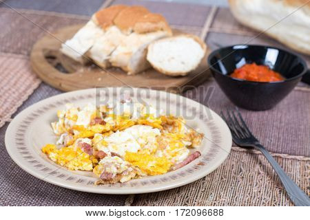 Breakfast table with fried eggs and bacon.