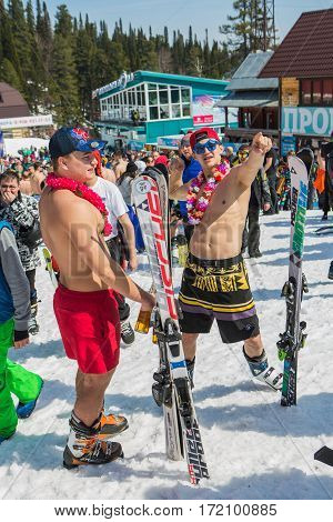 Group Of Young Happy Pretty Women On A Snowboard In Colorful Bikini With Flags.