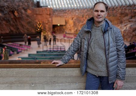 Mature tourist in Temppeliaukio Church, Helsinki, Finland