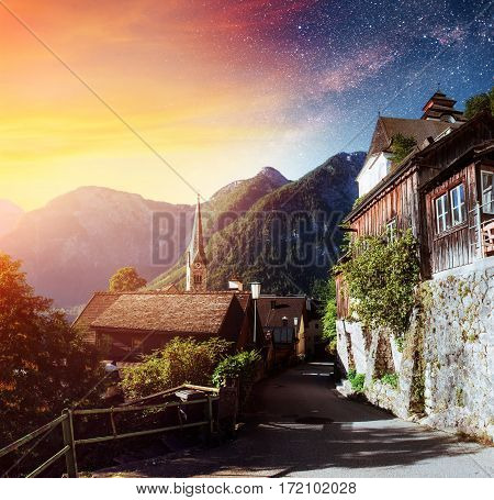 Scenic panoramic view of the famous mountain village in the Austrian Alps. Fantastic milky way. Starry sky. Hallstatt. Austria