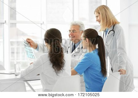 Team of doctors exploring roentgenogram in clinic