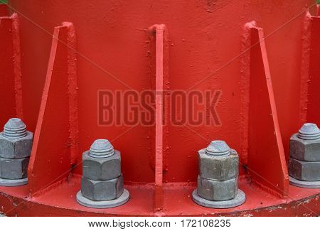 Steel bolt and nuts on steel plate for fasteners of the bottom of electric pole that red color selective focus