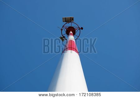 Transmission antenna radio tower pole on clear blue sky background center composition