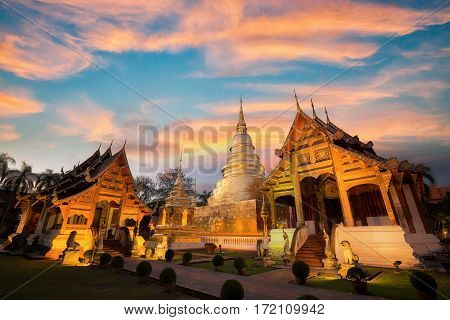 Wat Phra singh temple in chiang mai Thailand wood church and goldent pagoda with sunset sky. Phrasingh temple