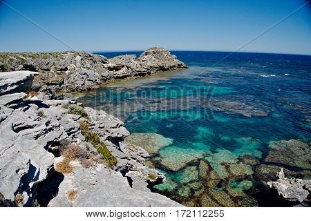Rocky cliff with crystal blue sea water
